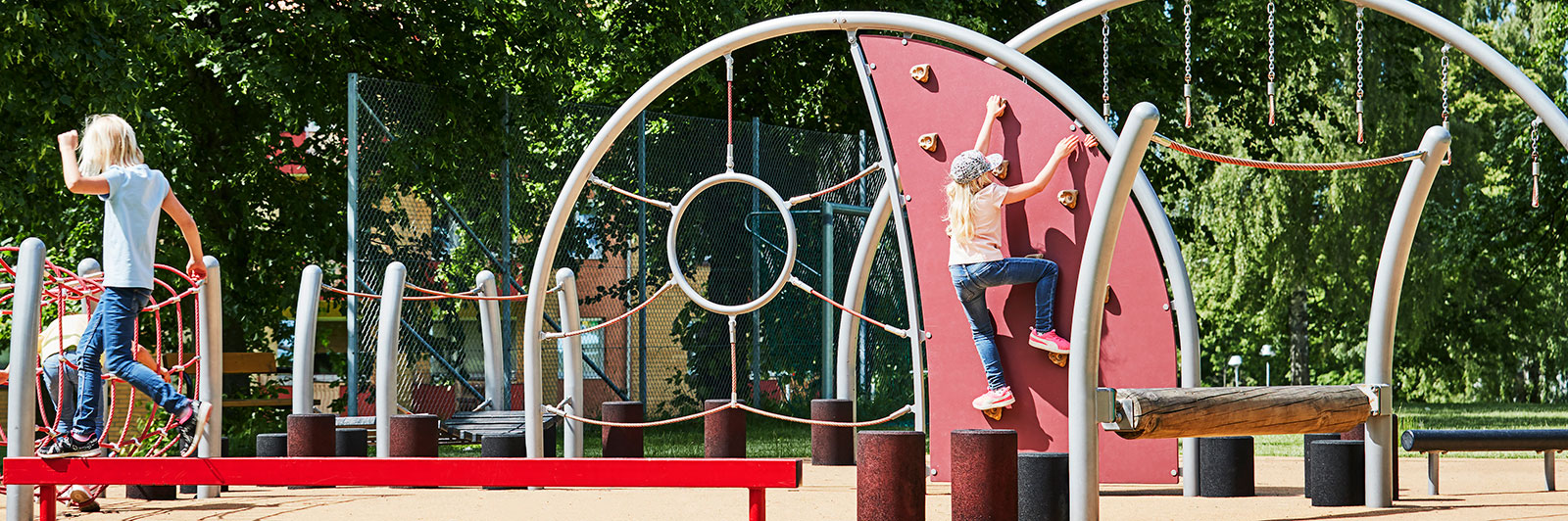 A large steel structure obstacle course with climbing walls, nets and balancing trails.